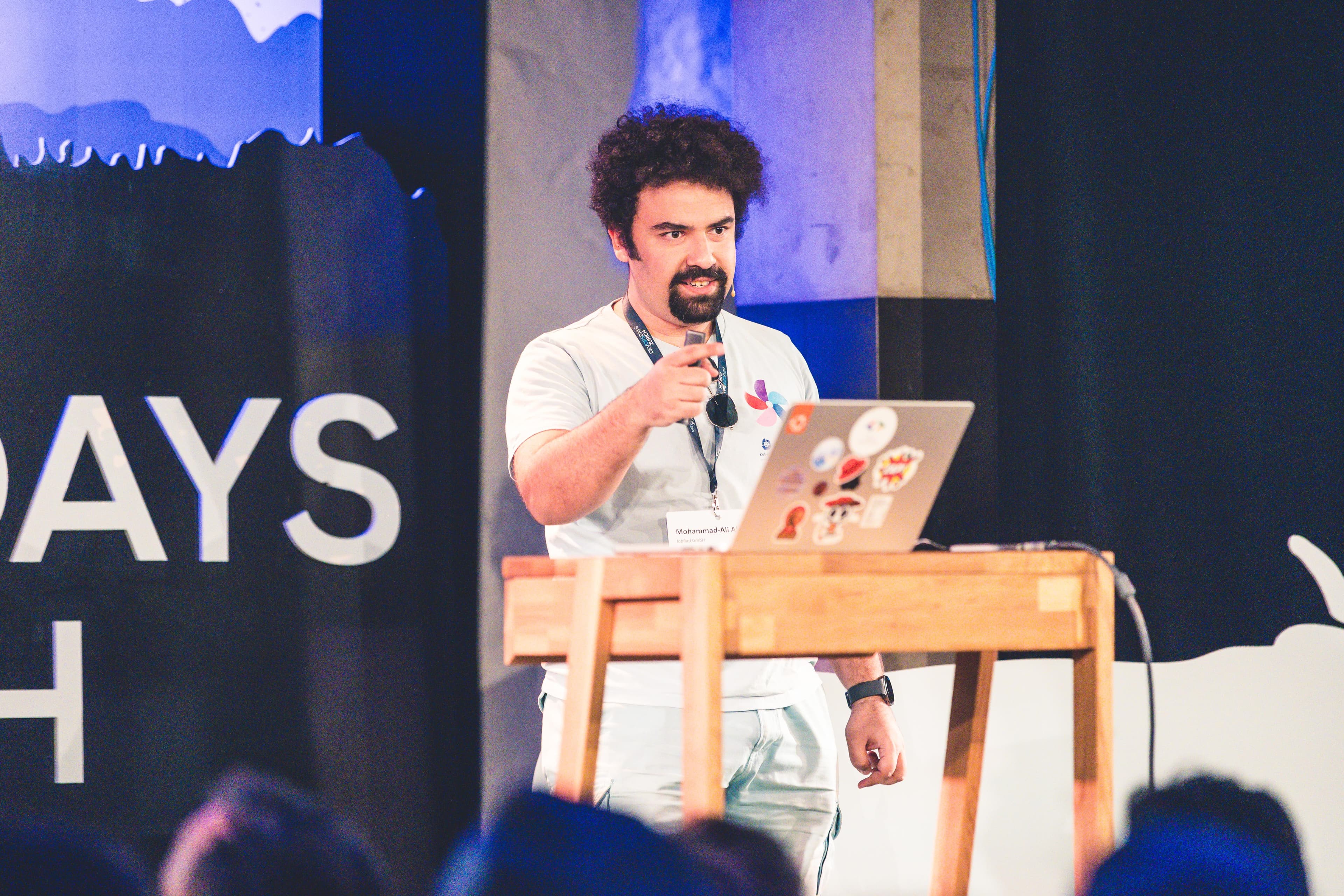 Mohammad-Ali A'râbi speaking on stage during Beyond SBOMs at DevOpsDays Zurich 2026.